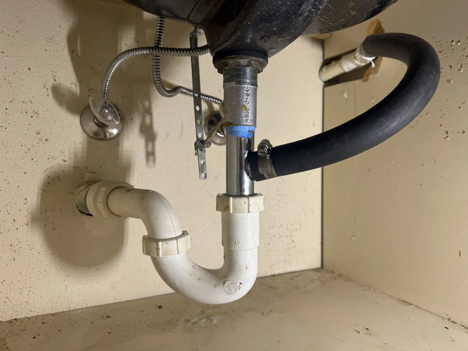 The new Y-branch tailpiece and hose under the guest sink