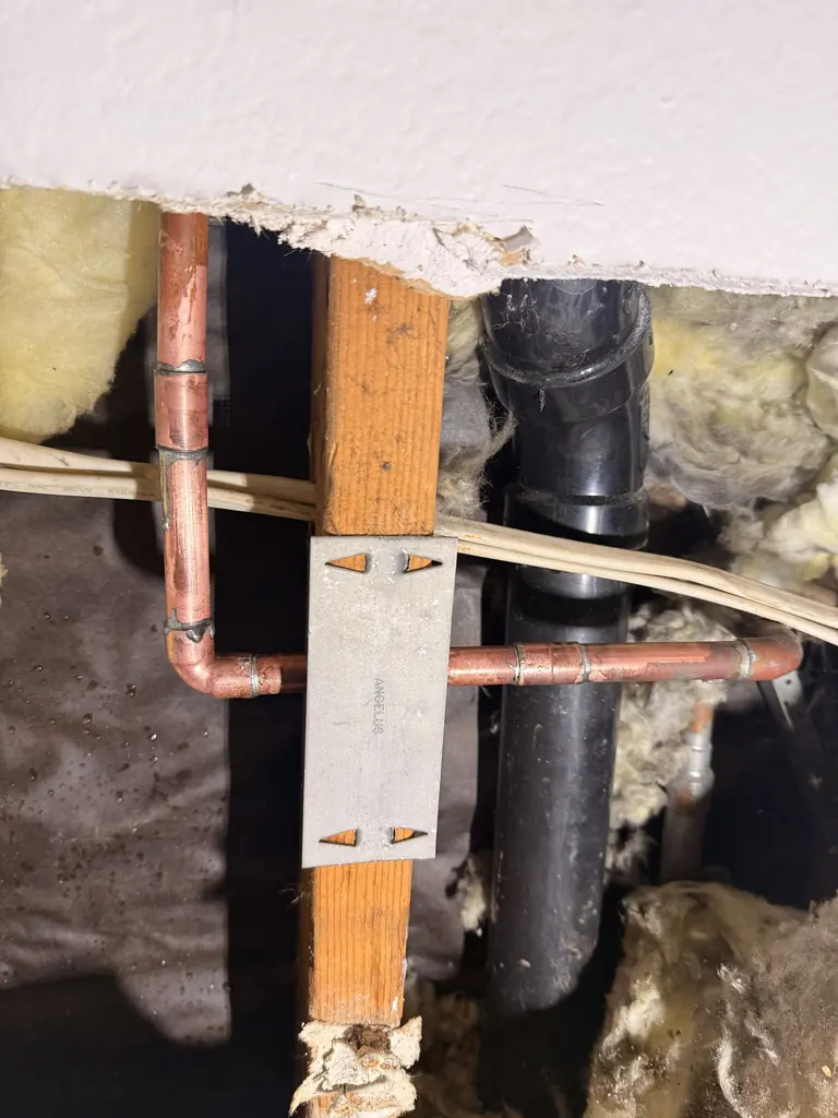 The new copper section soldered in behind the dining room wall
