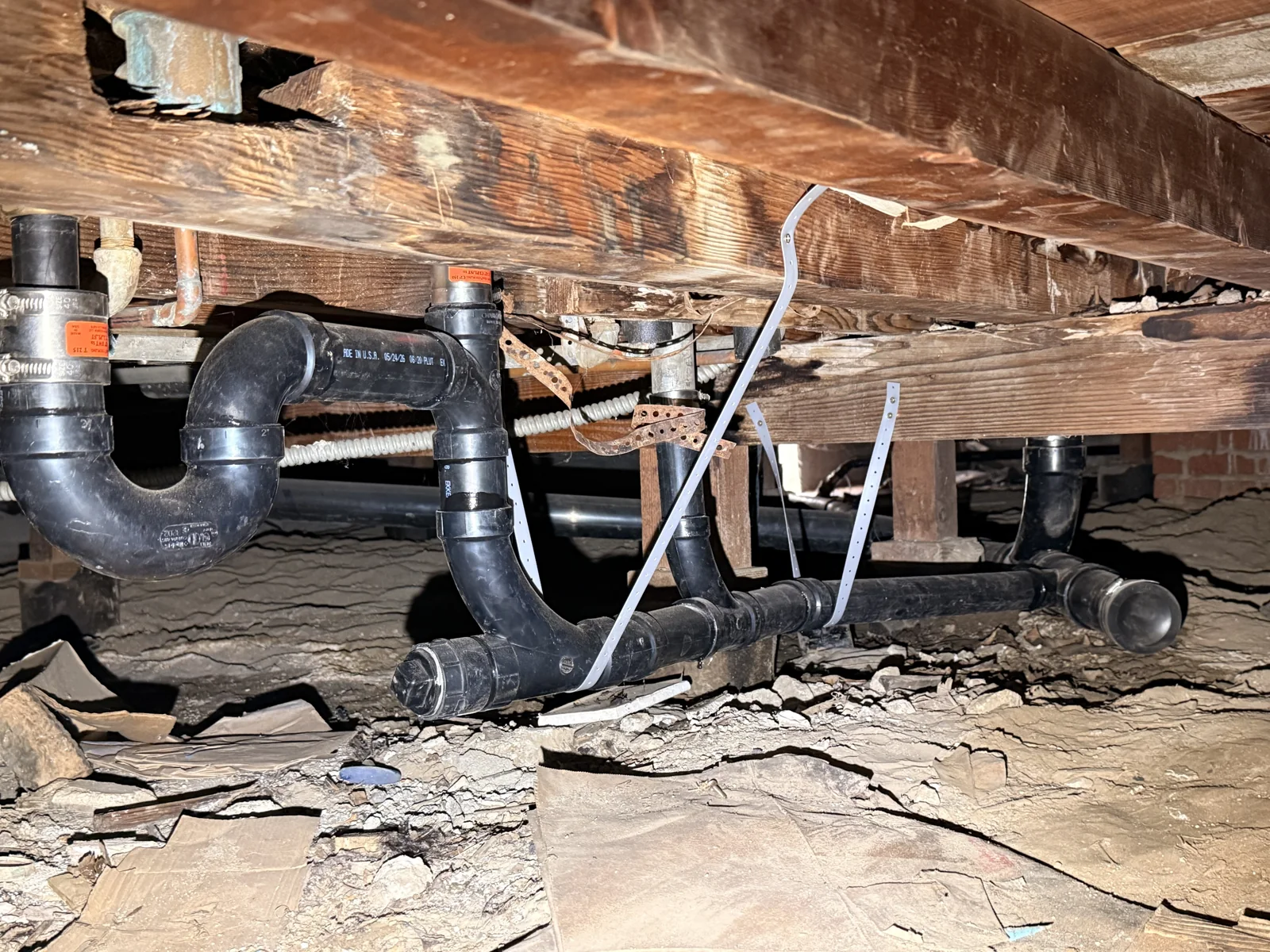 New drain piping beneath the home