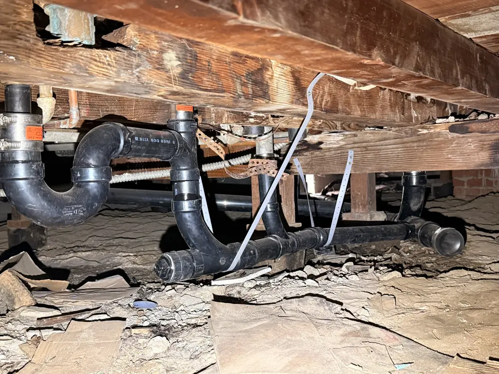 New drain piping beneath the home