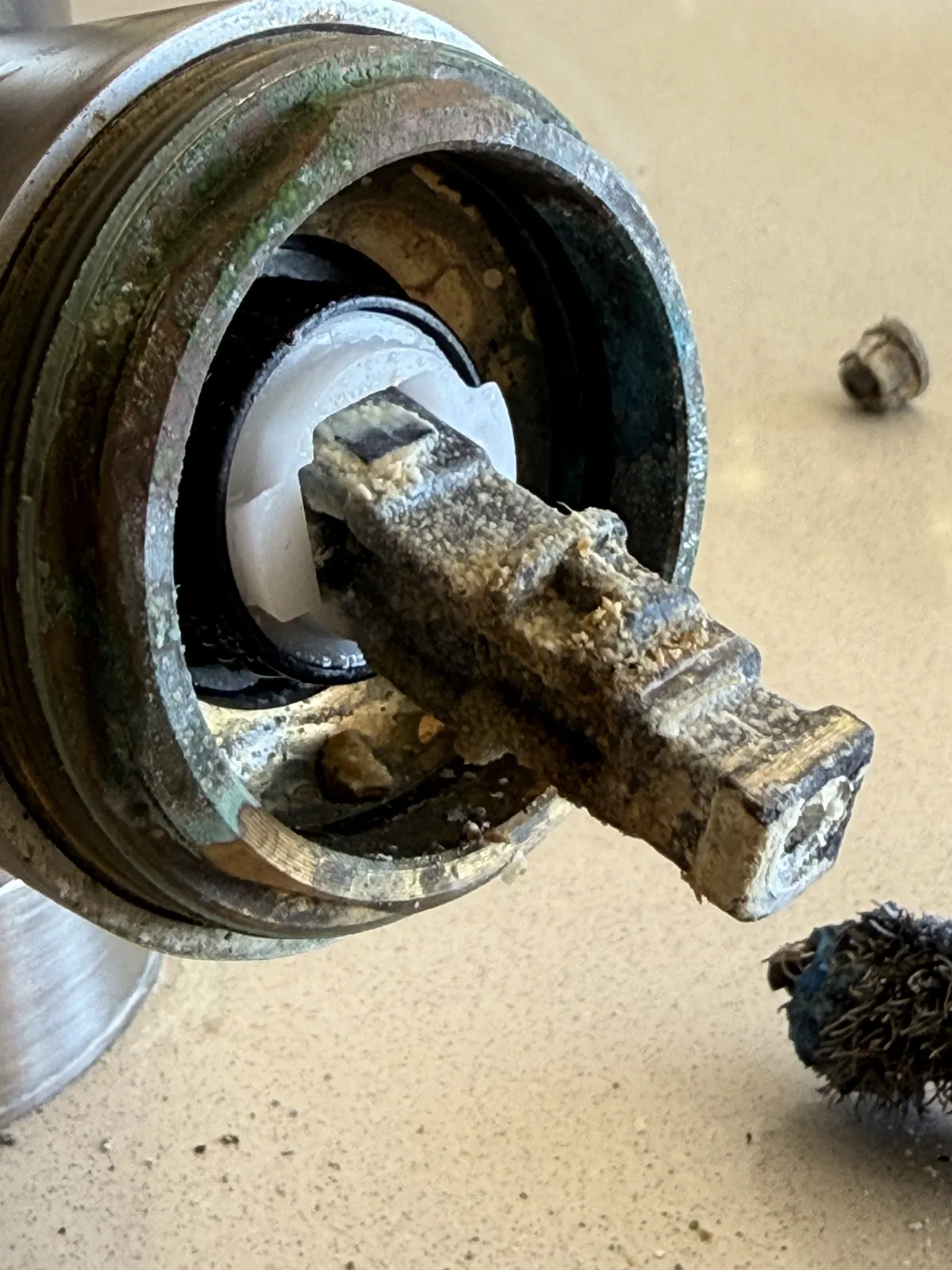The failed cartridge, worn and caked with mineral buildup