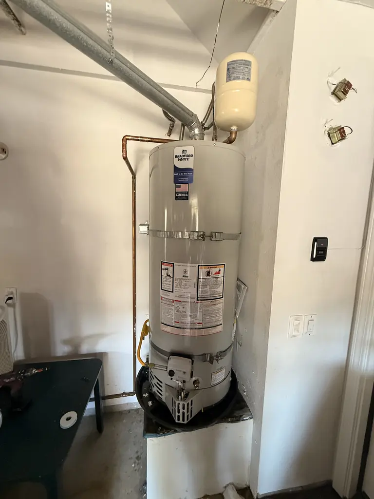 The new 50-gallon Bradford White with its expansion tank and drain pan